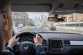 Selective focus of man hands on steering wheel driving a car on the speed highway. View from above. Moscow. Russia. Royalty Free Stock Photo