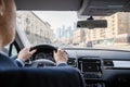 Selective focus of man hands on steering wheel driving a car on the speed highway. View from above. Moscow. Russia. Royalty Free Stock Photo