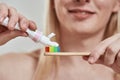 Selective focus of man pouring paste on toothbrush Royalty Free Stock Photo