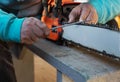 Selective focus on a man`s hands and an old electric saw. Man restores an electric saw