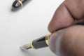 Selective focus of man is signing with a fountain pen Royalty Free Stock Photo