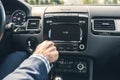 Selective focus of  man using car audio stereo system while driving his car. Royalty Free Stock Photo