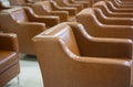 Selective focus of many leather couches in rows inside building indoor for people waiting shows concept of minimalism and pattern Royalty Free Stock Photo