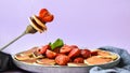 Selective focus on Maple syrup pouring on fork with tiny pancakes and strawberry. Pancake porridge, mini pancakes cereal in a bowl Royalty Free Stock Photo