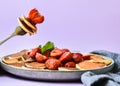 Selective focus on Maple syrup pouring on fork with tiny pancakes and strawberry. Pancake porridge, mini pancakes cereal in a bowl Royalty Free Stock Photo