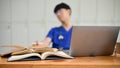 Selective focus, Medical books and a laptop on a wooden table over blued background