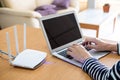 Selective focus at men hand while type on computer laptop keyboard while using internet. In front of high speed wireless internet