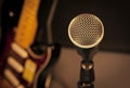 selective focus microphone and blur electric guitar background a Royalty Free Stock Photo