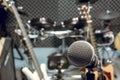 selective focus microphone and blur musical equipment guitar ,bass, drum piano background. Royalty Free Stock Photo