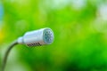 Selective focus of microphone on blurred green background Royalty Free Stock Photo