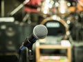 Selective focus on microphone with blurry music studio background