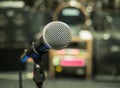 Selective focus on microphone with blurry music studio background