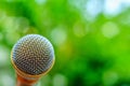 Microphone on natural blurred green background Royalty Free Stock Photo