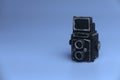 Selective focus of miniature camera isolated on a blue background with a copy space Royalty Free Stock Photo