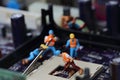 Selective focus of miniature engineer and worker fixed and repair CPU processor,  mainboard computer and use for business Royalty Free Stock Photo