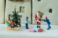 Selective focus on miniature figure Santa claus giving present t