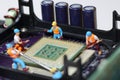 Selective focus of miniature foreman control engineer worker to fixed problem Control Processing Unit CPU,  mainboard computer Royalty Free Stock Photo