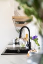 Selective focus on modern kitchen sink with black faucet Royalty Free Stock Photo