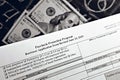 Selective focus monochrome photo of paycheck protection program borrower application form revised, on a background of dollar bills Royalty Free Stock Photo