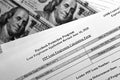 Selective focus monochrome photo of paycheck protection program loan forgiveness application form on a background of dollar bills Royalty Free Stock Photo