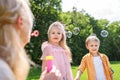 selective focus on mother blowing soap bubbles while spending time with kids Royalty Free Stock Photo