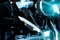 Selective focus on a motorcycle air filter with blur engine and shiny exhaust pipe. Motorcycle dealership business. Shiny chrome Royalty Free Stock Photo