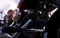 Selective focus on a motorcycle engine. Closeup motorcycle exhaust pipe, engine guard, air filter, and rear brake pedal. Royalty Free Stock Photo