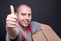 Selective focus of mover guy holding box showing like Royalty Free Stock Photo