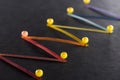 Selective focus of multicolored abstract connected lines with pins on black background, connection and communication Royalty Free Stock Photo