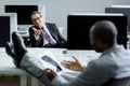 selective focus of multicultural businessmen having conversation at workplace Royalty Free Stock Photo