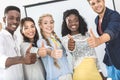 selective focus of multiethnic smiling business people showing thumbs up