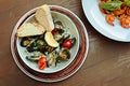 Selective focus of mussels with tomatoes and basil