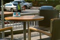 Selective focus on non-smoking sign on the wooden vintage table and vacancy chairs at the terrace of coffee shop in the afternoon Royalty Free Stock Photo