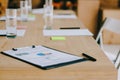 selective focus of notepad, stationery and glasses of water at workplace