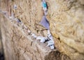 Selective focus on notes to God in the cracks between the bricks of the Western Wall, also known as Kotel, in the old