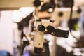 Selective focus of ocular eyepiece lenses and tube of binocular microscope for lab technician in laboratory research in hospital Royalty Free Stock Photo