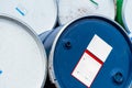 Selective focus on old chemical barrels. Blue oil drum. Steel oil tank. Toxic waste warehouse. Hazard chemical barrel with warning Royalty Free Stock Photo