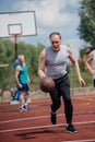 selective focus of old friends playing basketball