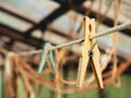 Selective focus on an old yellow clothespin on a rope close-up