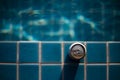 selective focus, one can of white beer placed on the edge of the pool bright blue water background feel fresh The background image Royalty Free Stock Photo