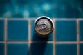 selective focus, one can of white beer placed on the edge of the pool bright blue water background feel fresh The background image Royalty Free Stock Photo