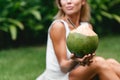 Selective focus of open fresh green coconut in hand