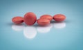 Selective focus on orange round tablets with shadow on gradient background. Pharmaceutical industry. Pharmacy products. Vitamins