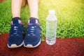 Selective focus on overshoe, one fat woman start running for healthy in green grass, jogging exercise at park alone