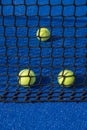 Selective focus, paddle tennis balls behind the net of a blue paddle tennis court Royalty Free Stock Photo