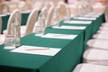 Selective focus of Paper, pencil, water bottle, glass  on the table in the seminar room background Royalty Free Stock Photo