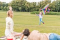 selective focus of parents looking at daughter playing with kite Royalty Free Stock Photo