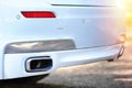 Selective focus on parking sensor exhaust pipe bumper at rear of white luxurious car bumper close up Royalty Free Stock Photo