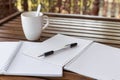 Selective focus of Pen, notebook , coffee cup on the wooden table and copy space Royalty Free Stock Photo