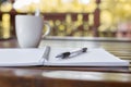 Selective focus of Pen, notebook , coffee cup on the wooden table and copy space Royalty Free Stock Photo